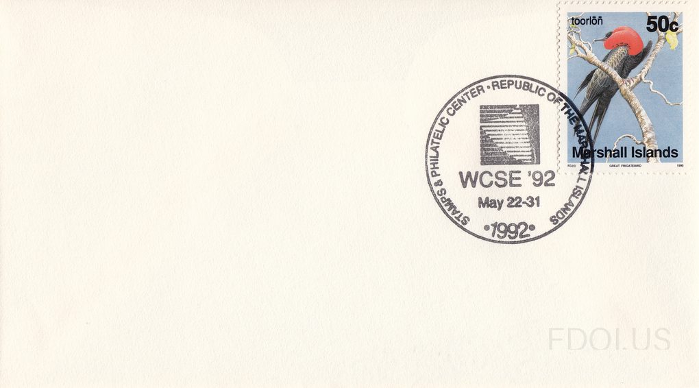 Plain white envelope with no cachet artwork on the left side. The stamp is a 50-cent Marshall Islands definitive issue depicting a Great Frigatebird (toorlon) perched on a branch, shown in black with a distinctive red throat pouch against a blue background. The pictorial cancel is a circular hand s…